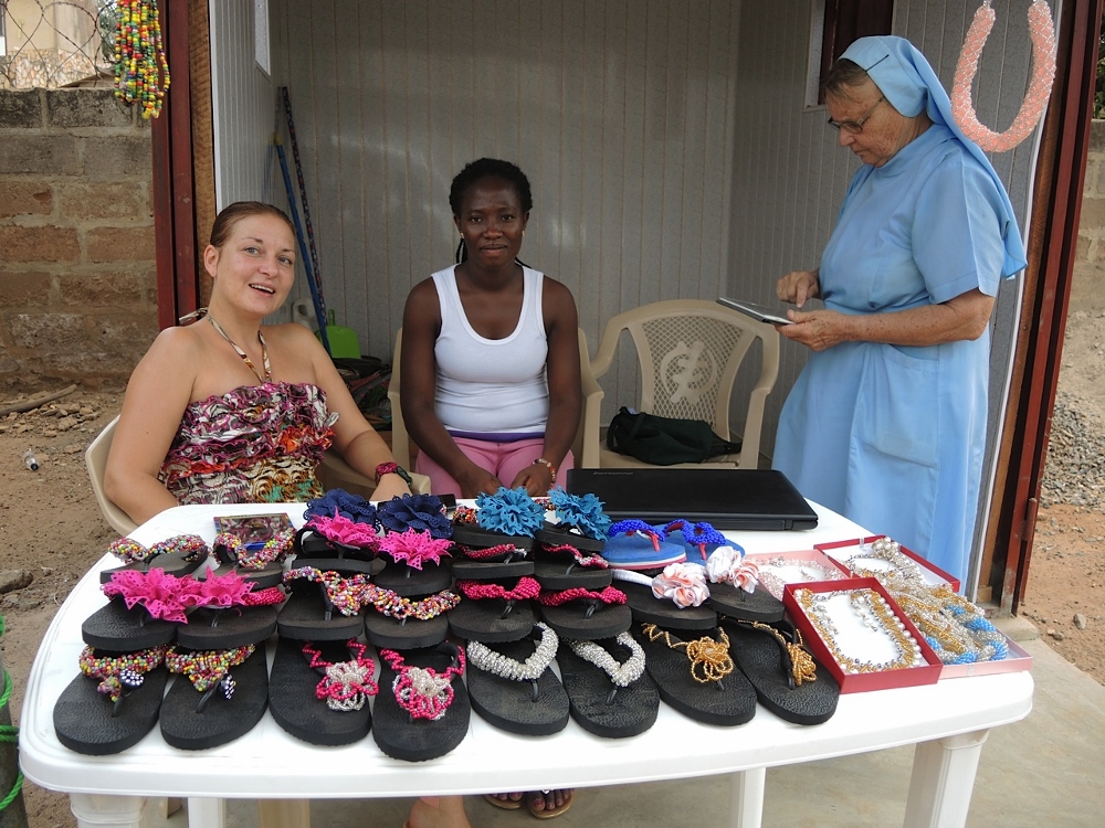 On Feb. 8, the Girls Porter Project opened a kiosk that is a 15-minute drive from the market in hopes of selling the beadwork that the girls learn during some of their informal classes. Sr. Angelina Gerharz, right, examines the goods with social worker Mavis Oppong, 23, and Yvonne Rogatsch, a volunteer from Austria. (GSR photo / Melanie Lidman)