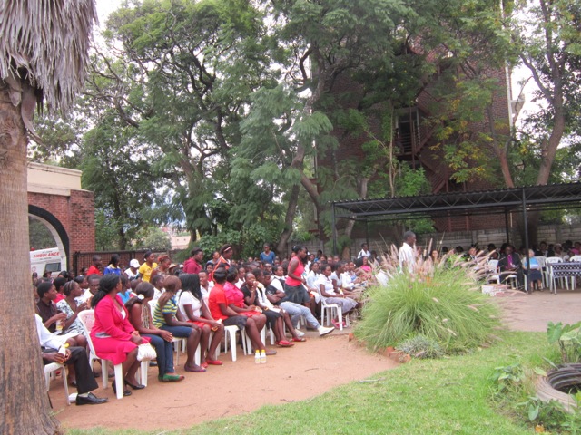 Five hundred teenagers gathered in their very best clothes at St. John’s headquarters for their graduation ceremony. “They earn a dollar here, a dollar there, and they buy a shirt, a skirt or a couple of dreads for that. Bit by bit they build up a smart wardrobe,” said Clara Mutambiwa, course co-ordinator. (Jill Day)
