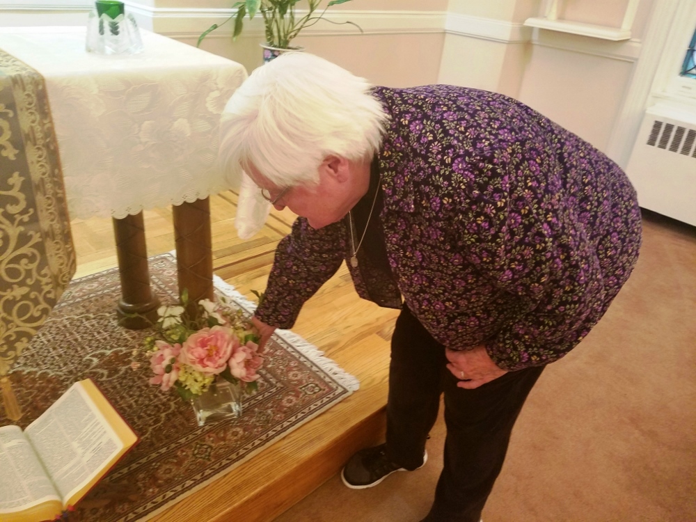 Sr. Mary Petrosky places flowers in the chapel of the Holy Name of Jesus Convent. (GSR photo / Chris Herlinger)