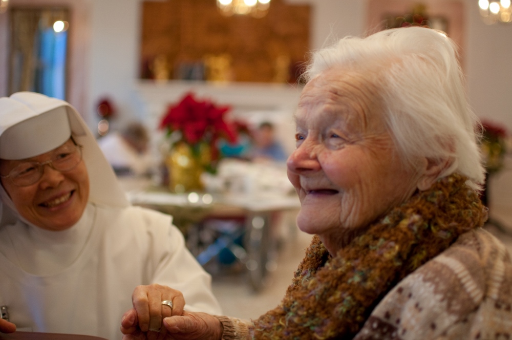 Sr. Joanna sits with resident at Santa Teresita, at the elder care facility in Duarte, Calif. The facility now offers a continuum of care for elders and was first established as a tuberculosis sanatorium for women and girls in 1930. (Courtesy of Carmelite Sisters of the Most Sacred Heart of Los Angeles)