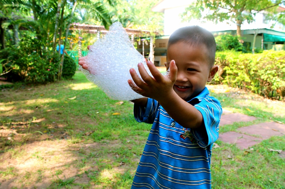 Nong Gaa, 3, playing with bubbles. (Bridgid O’Brien)