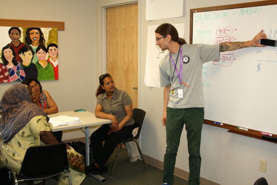 Notre Dame AmeriCorps Boston volunteer Nason Heywood leads an adult basic math class at the Notre Dame Education Center in South Boston. Heywood is just wrapping up his second year of teaching at the center. (GSR photo/Tara García Mathewson)