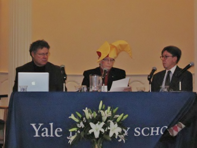 Sr. Patricia Siemen, Barry Law School, center, presents her talk while wearing a jester’s hat to represent how law must be turned upside down to address the rights of nature and the future. (Joan Brown)