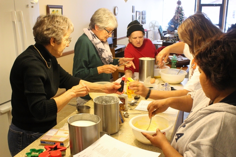Baking class at Neighbor to Neighbor, downtown day center for women that just might be the Sisters of St. Joseph’s most popular Concordia ministry. (Nicholas Sciarappa)