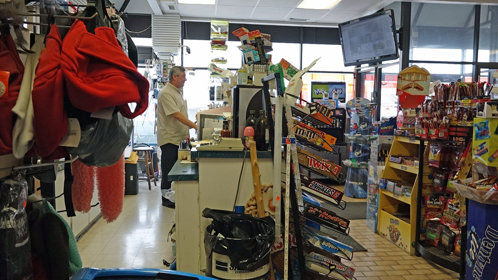 Hassan El Khodr greets customers at his convenience store in Chatham. (Dana Wachter)