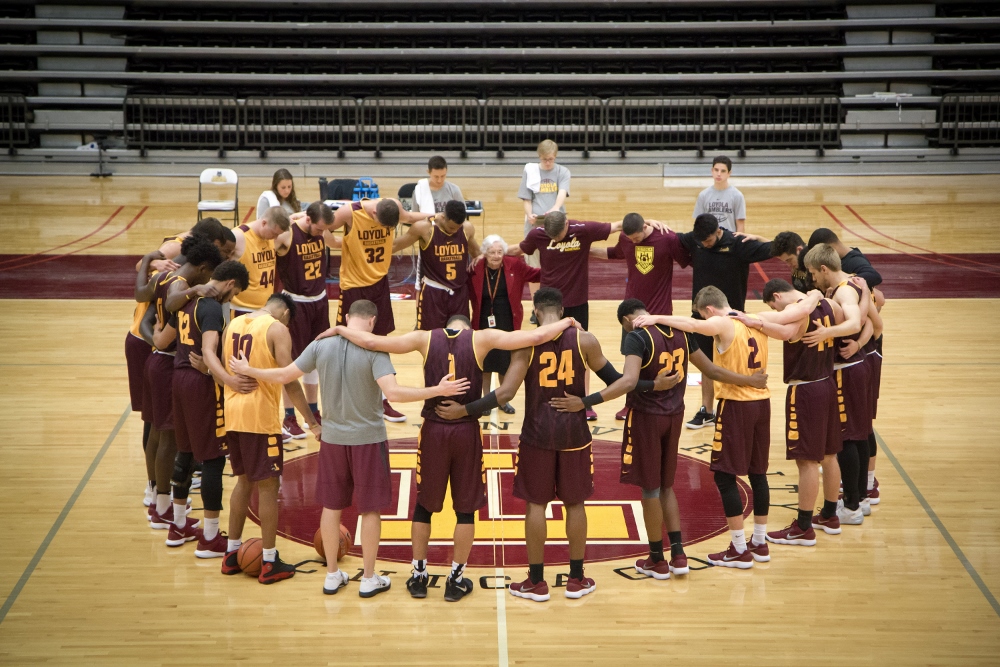 Sr. Jean Dolores Schmidt prays with the Loyola University Chicago men's basketball team in 2018. (CNS/Courtesy of Loyola University Chicago/Bill Behrns)