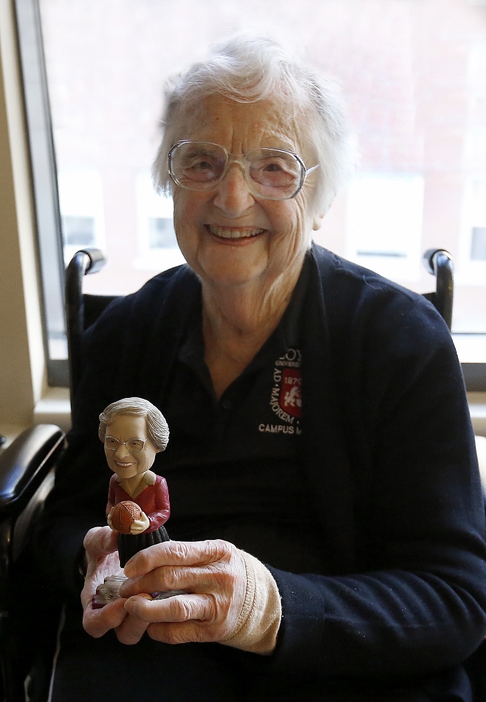 Sr. Jean Dolores Schmidt holds a bobblehead made in her likeness while recuperating from hip surgery in January. The bobblehead is sold in campus bookstores. (CNS / Chicago Catholic / Karen Callaway) Sr. Jean Dolores Schmidt holds a bobblehead made in her likeness while recuperating from hip surgery in January 2018.