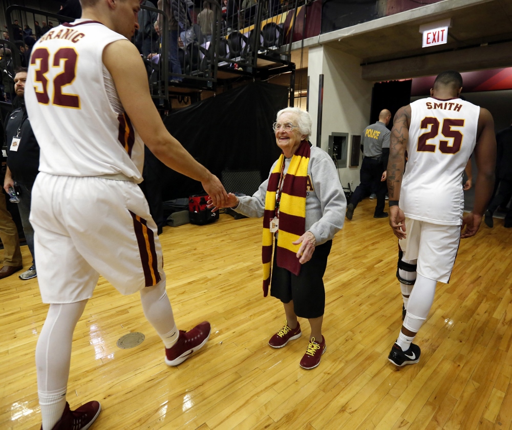 Sr. Jean Dolores Schmidt greets Loyola University Chicago men's basketball players after a Feb. 12, 2018, game. (CNS/Chicago Catholic/Karen Callaway)