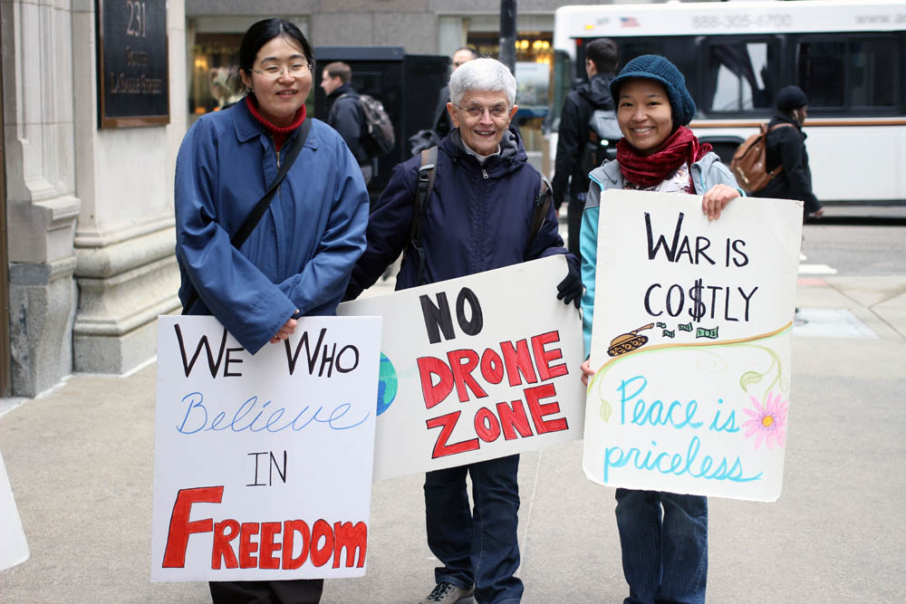 Sr. Kathleen Desautels, center, with 8th Day Center intern Elsa Loekito, right, and a friend of Loekito's at a peace vigil in 2017 (Courtesy photo)