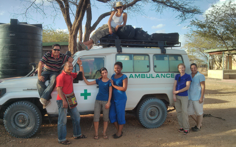 Sr. Karen Schneider, right, two missionary priests and four residents pose with an ambulance the group used to travel around northern Kenya.