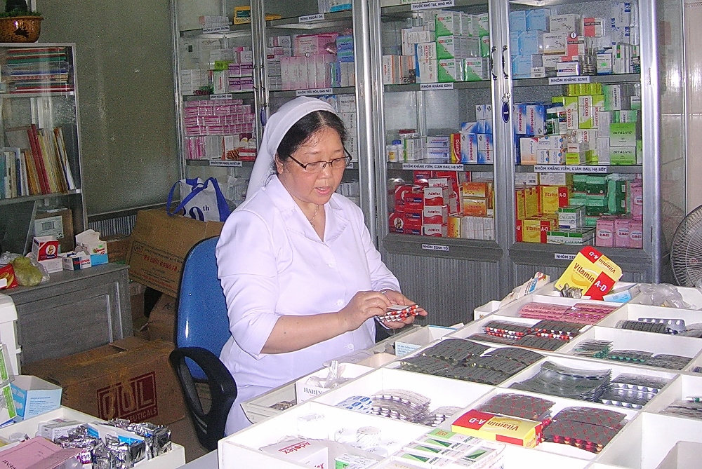 Visitation Sr. Teresa Nguyen Thi Kim Lan works at her congregation's pharmacy. She is also vice director of the Catholic Group for Climate Change Prevention working to help poor farmers in central Vietnam develop effective sustainable ways to use their land. (Peter Nguyen)