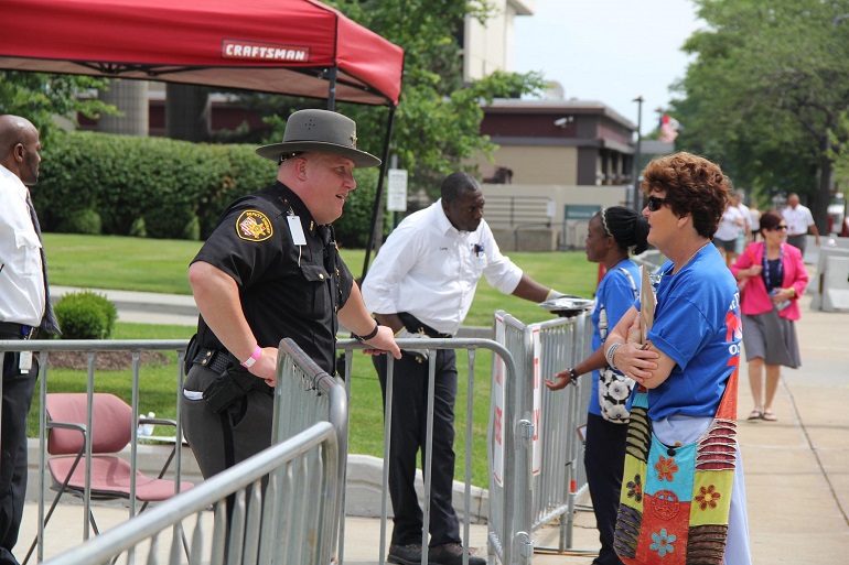 On the road with Nuns on the Bus in July, Sr. Mary Ellen Lacy talks with an officer at the Republican National Convention in Cleveland. (Network / Jennifer Wong)