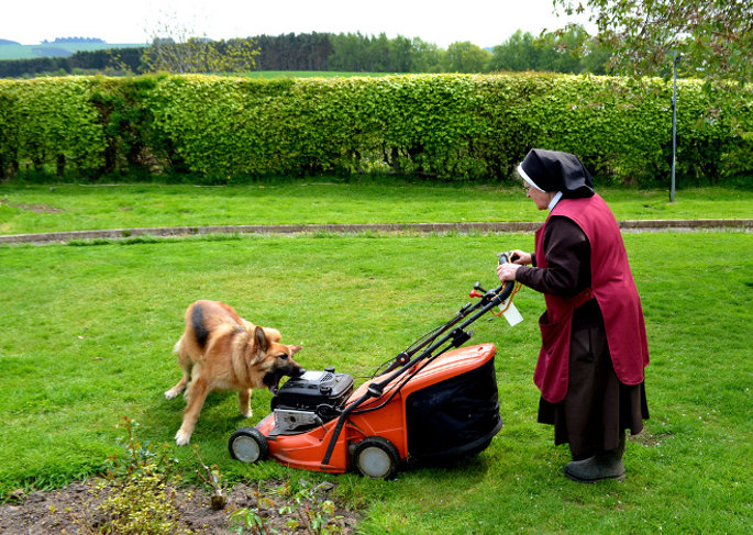 A sister of the Poor Clare Monastery in rural Scotland mows the lawn. This photo is part of a new series by photographer Craig Buchan that shows women religious doing everyday tasks.