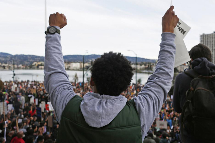 A demonstrator in Oakland, California, protests Dec. 13, 2014, against police violence. (CNS/Reuters/Stephen Lam)