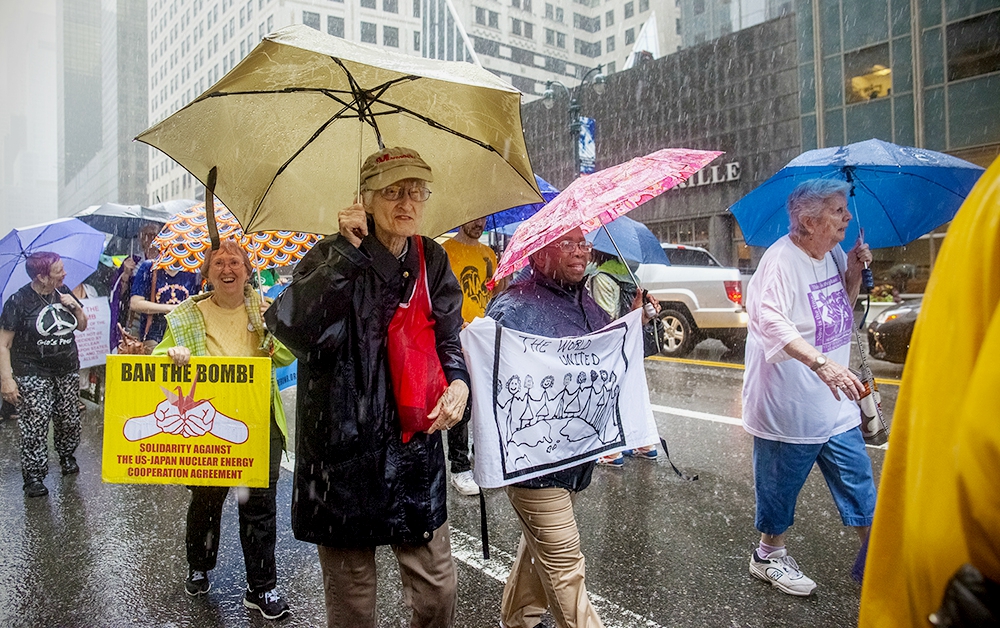 Maryknoll Sr. Jean Fallon, 87, center, marches with fellow Maryknoll Sr. Elizabeth Zwareva, holding white banner, near the United Nations in June 2017. (Provided photo)