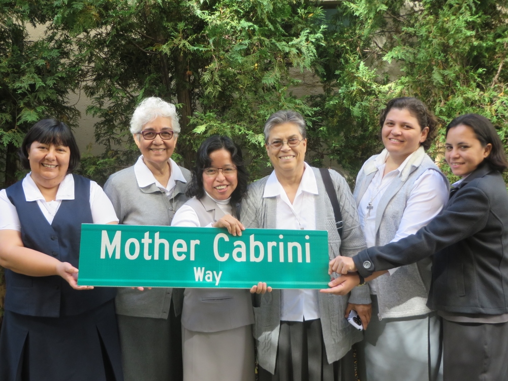 Missionary Sisters of the Sacred Heart of Jesus pose with the new street sign for Mother Cabrini. (Courtesy of Missionary Sisters of the Sacred Heart of Jesus)