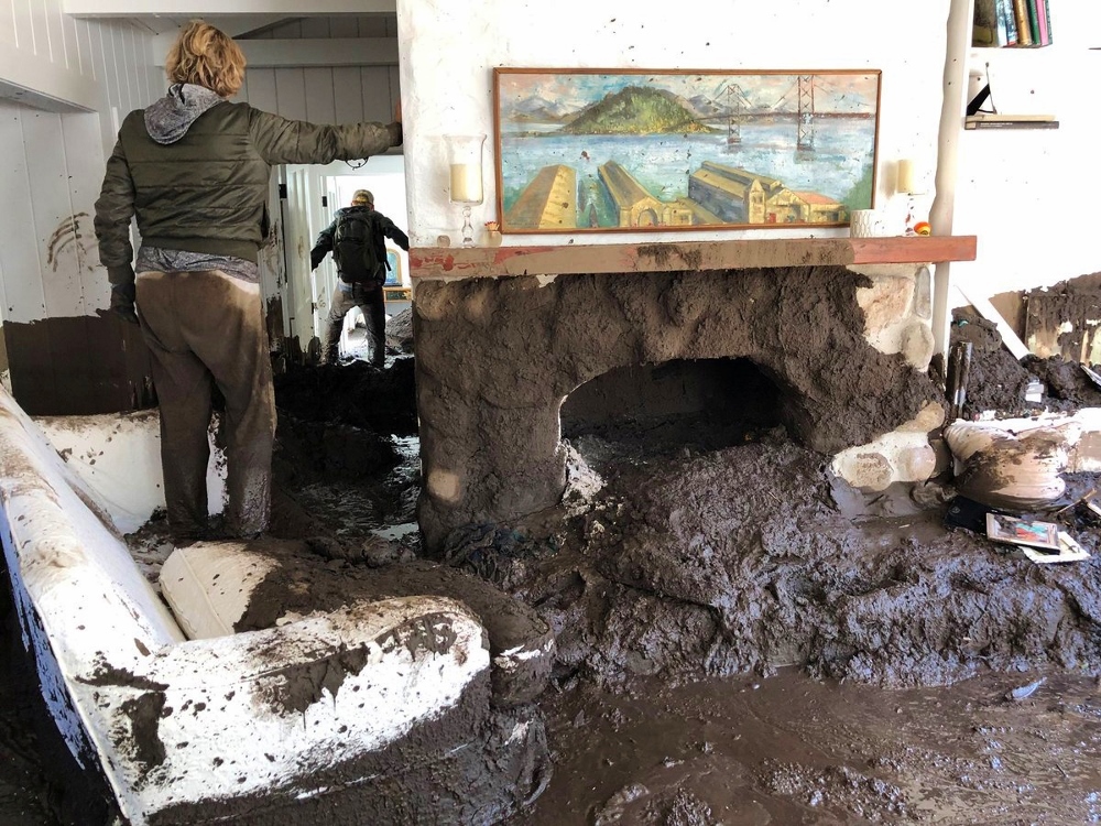 Family members inspect the inside of their home Jan. 10 after mudslides in Montecito, California. (CNS / Reuters / Santa Barbara County Fire Department handout)