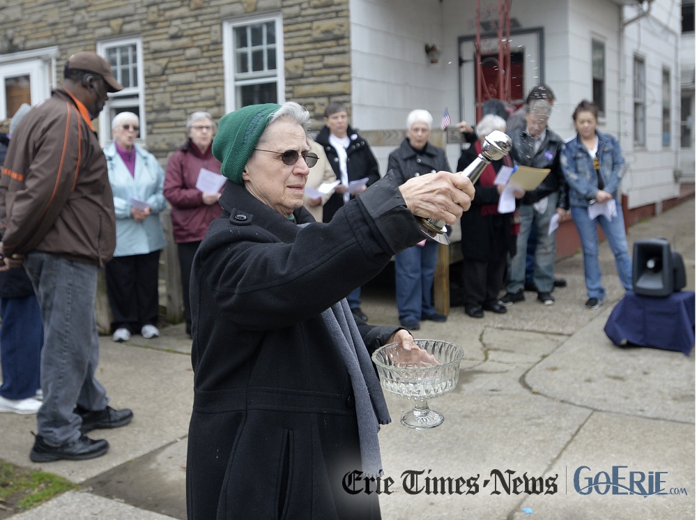 Mercy Sr. Mary Paul sprinkles holy water during a vigil for Robert McCarthy outside his Erie home March 28. McCarthy was stabbed to death and set on fire Feb. 5 outside his home on East Ninth Street in Erie. (Erie Times-News / Dave Munch / Reprinted with permission from Times Publishing Company, Erie, PA, Copyright 2017)