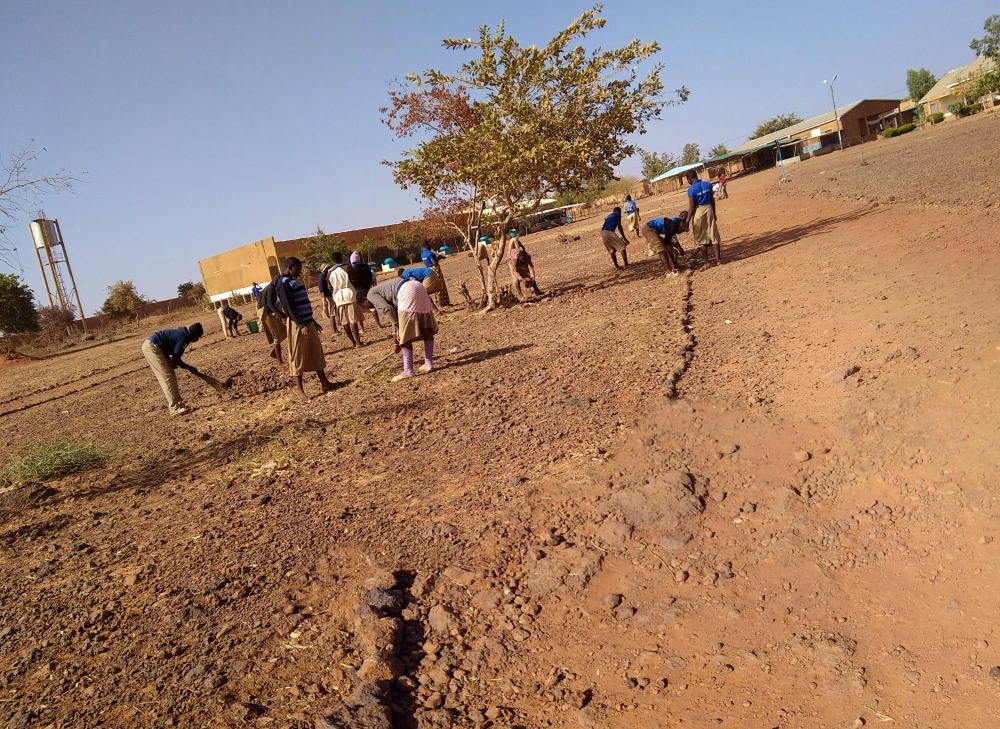 Students at one of the sisters' hostels prepare the ground for planting gardens. (Provided by Sr. Marguerite Kankouan)