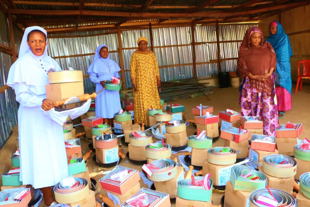 Sr. Agatha Chikelue, left, presents catering equipment to women as part of the women of faith Network empowerment program in Abuja. (Courtesy of Sr. Agatha Chikelue)