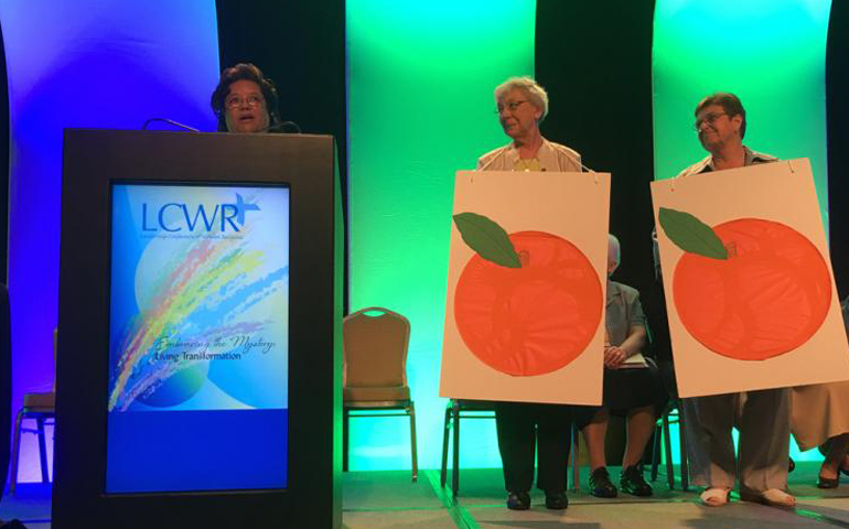 This year's assembly is co-hosted by three LCWR regions. Holy Family Sr. Greta Jupiter, at podium, is chair of the LCWR's Region 5. Catholic Felician Sr. Rose Marie Jasinski is chair of Region 4, and Congregation of St. Joseph Sr. Rosemary Brennan is chair of Region 1. (GSR/Dawn Araujo-Hawkins)