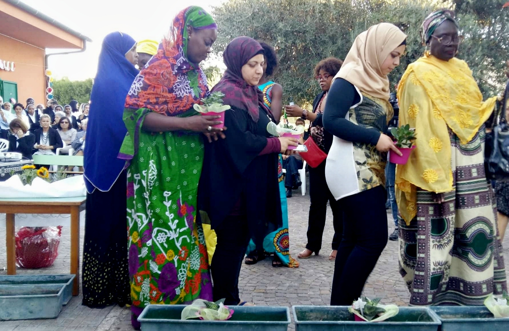 Women who are part of Chaire Gynai, a new project in Rome that provides support to migrant women, plant "seeds of hope" after the Sept. 30 inauguration of the project. (Philippa Hitchen)