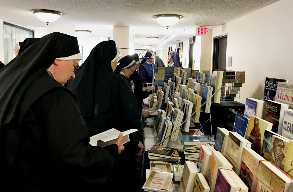 Attendees of the 2017 CMSWR annual assembly look over the book selection offered by the Pauline ministries on the first full day of the Oct. 12-15 assembly. (GSR photo / Dawn Araujo-Hawkins)