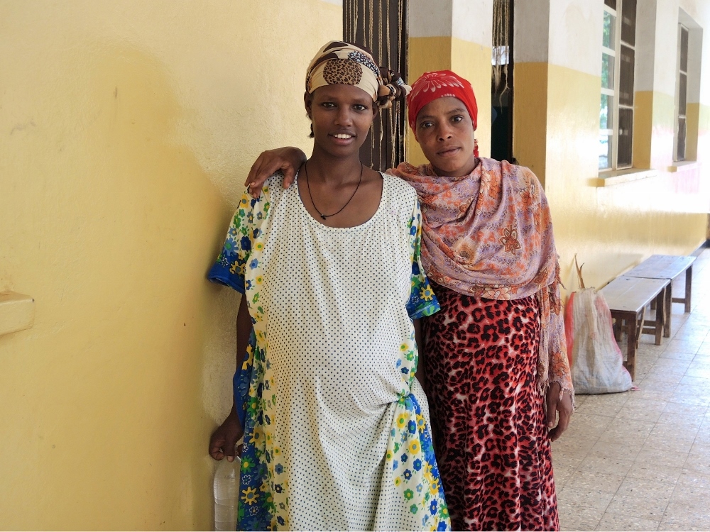Two expectant mothers outside the maternal waiting area. The hospital's main focus is maternal health and deliveries. (GSR photo / Melanie Lidman)