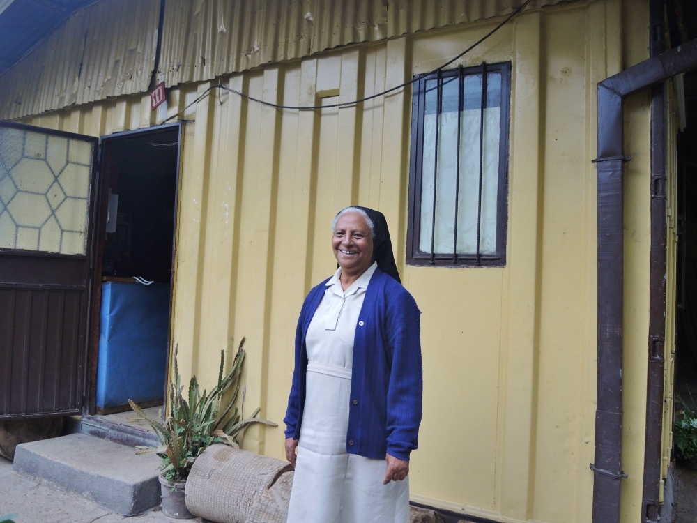 Sr. Senkenesh Gebre-Mariam, 76, outside one of the Medhen Social Center buildings in Addis Ababa, Ethiopia. Like with many nongovernmental organizations in Ethiopia, Gebre-Mariam was able to repurpose the shipping containers used to bring food during the 1980s famine into structures that she still uses today. (GSR photo / Melanie Lidman)
