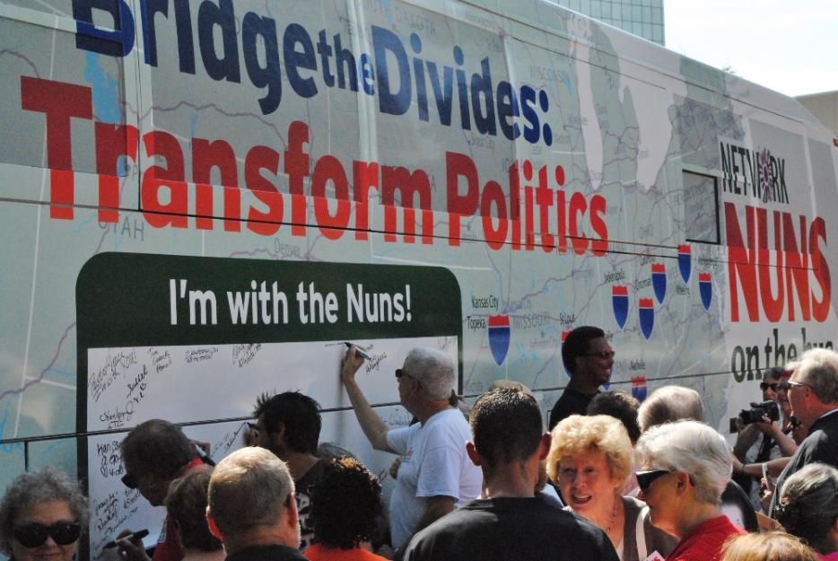 After the inaugural rally to begin the 2015 Nuns on the Bus tour, people were invited to sign their names in support of its goals. (GSR photo / Dawn Cherie Arajuo)