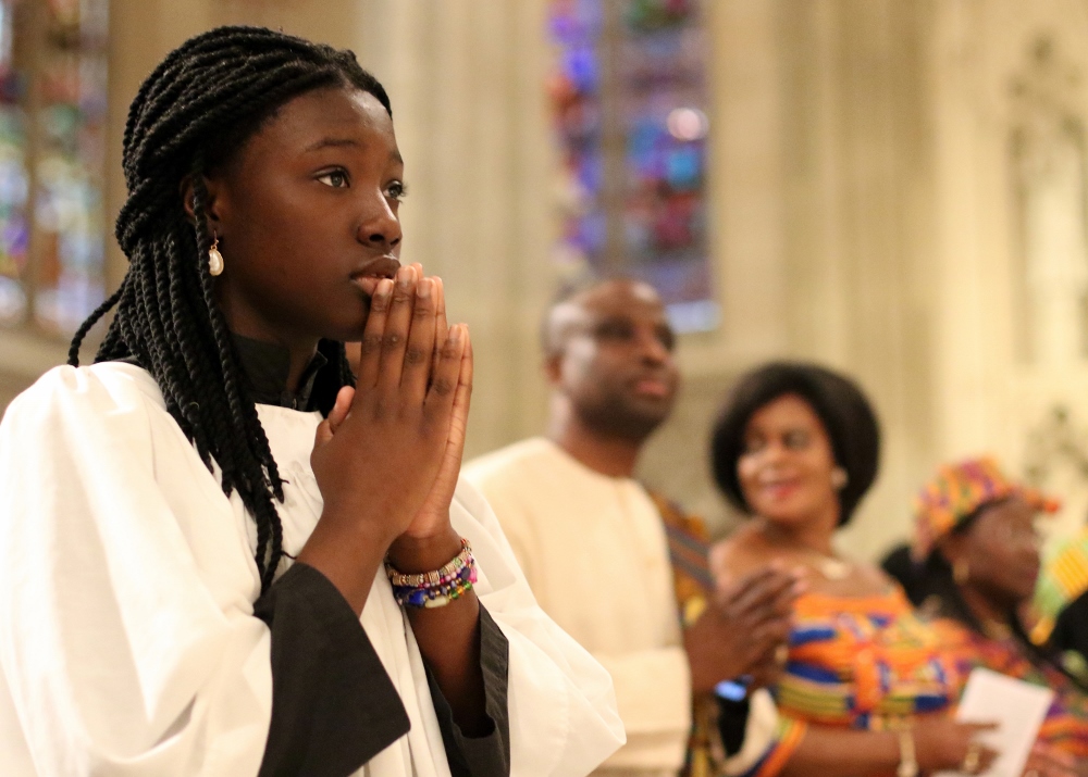 An altar server processes toward the sanctuary at the beginning of the annual Black History Month Mass on Feb. 4 at St. Patrick's Cathedral in New York City. (CNS / Gregory A. Shemitz)