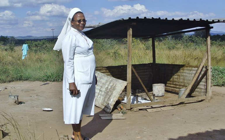 Precious Blood Sr. Ludo Ncube stands next to the outdoor kitchen for Sacred Heart Secondary boarding school. Learn more by reading the story by Marko Phiri below. 
