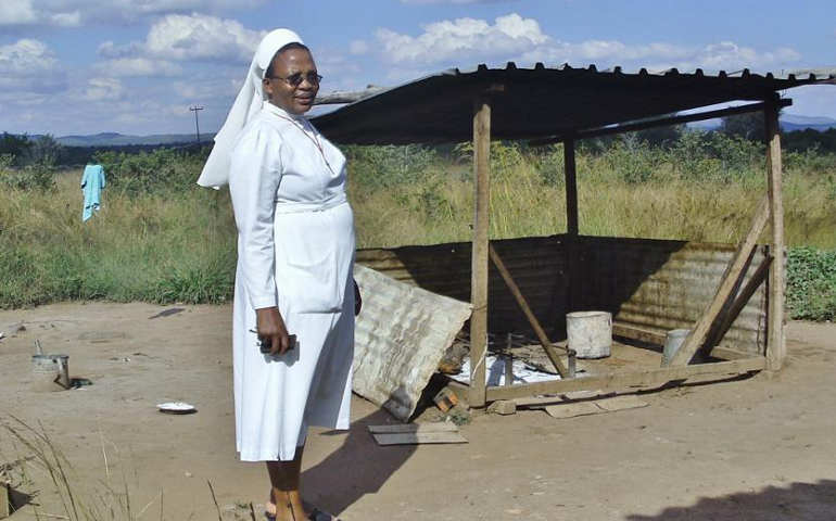 Precious Blood Sr. Ludo Ncube stands next to the outdoor kitchen for Sacred Heart Secondary boarding school. Learn more by reading the story by Marko Phiri below.