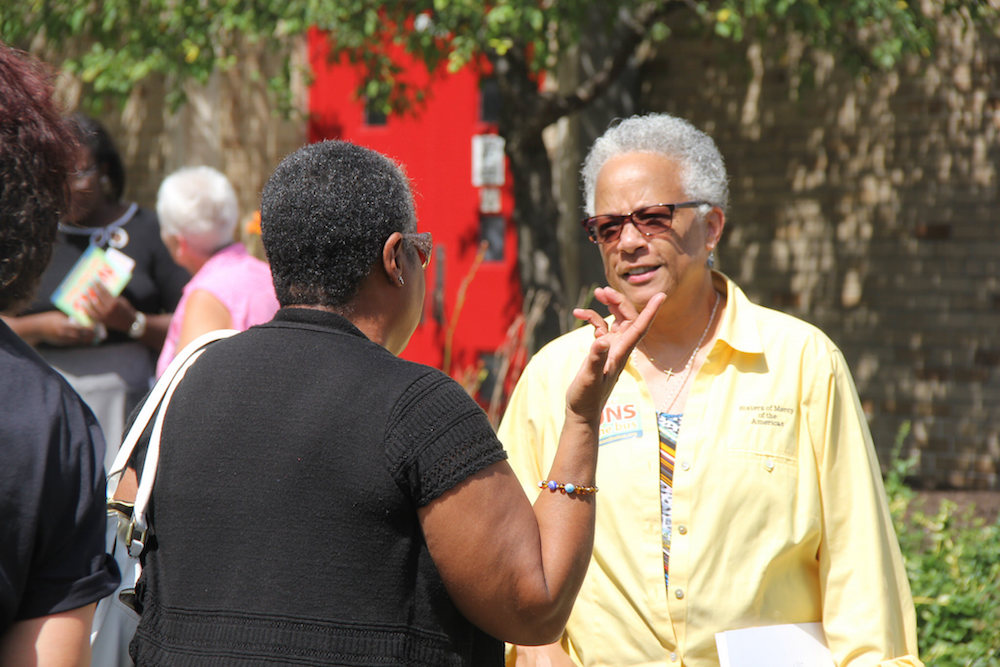 Sr. Larretta Rivera-Williams, right, talks to a community member July 15 in Indiana. (Jennifer Wong / Courtesy of NETWORK)
