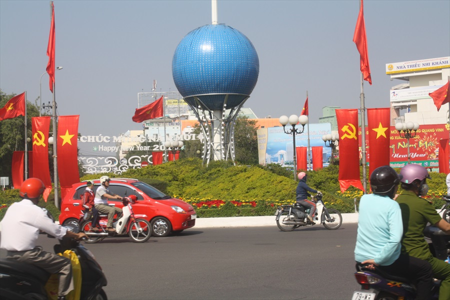 A roundabout n Nha Trang City is decorated with flowers and flags for the Lunar New Year, celebrated in 2014 beginning Jan. 27. Red is associated with good fortune. (Joachim Pham)