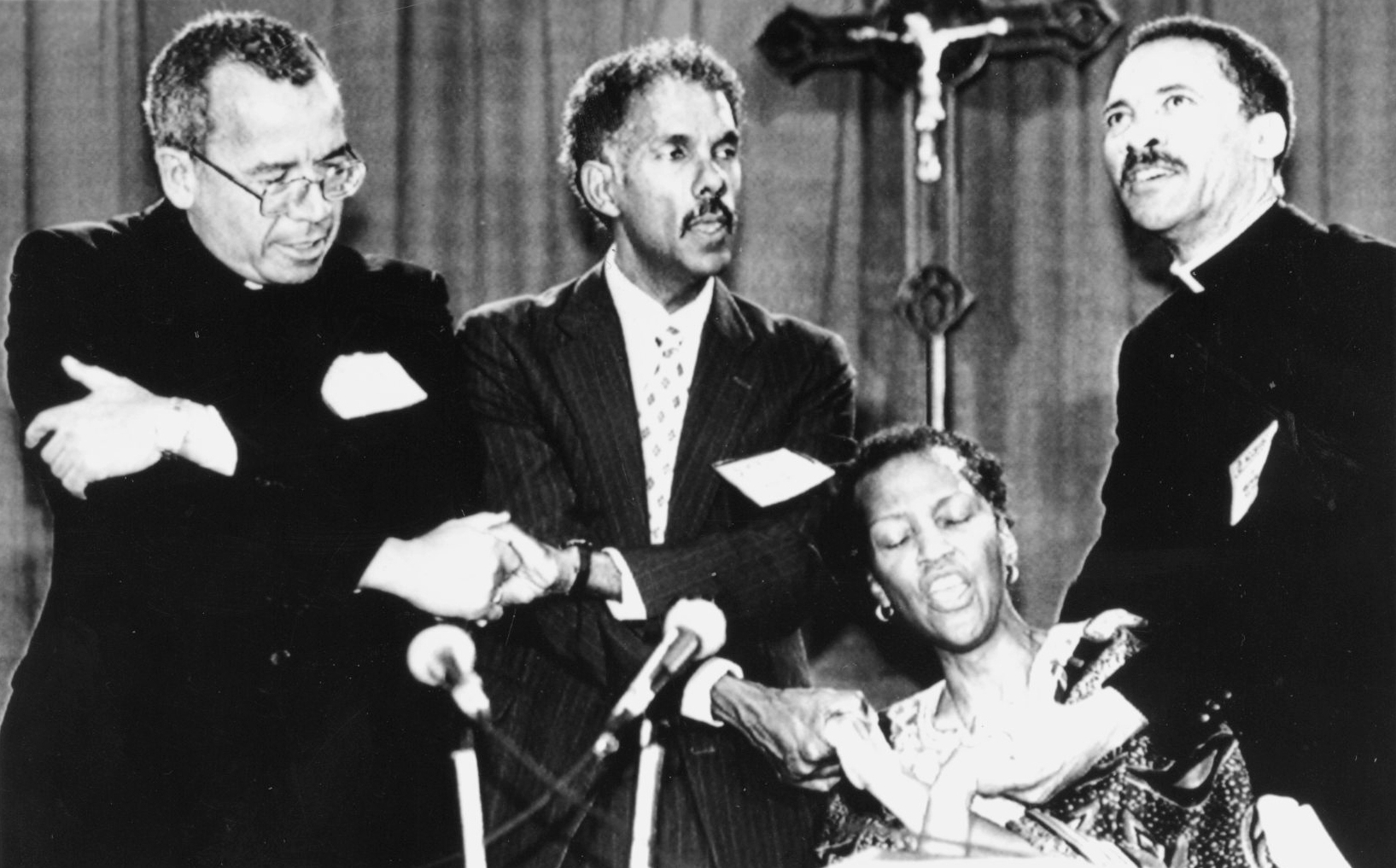 Sr. Thea Bowman, seated, leads the singing of “We Shall Overcome” during the U.S. bishops’ meeting in South Orange, New Jersey, June 19, 1989. With Bowman are, standing from left, Atlanta Archbishop Eugene Marino, Albert Raboteau and Baltimore Bishop John