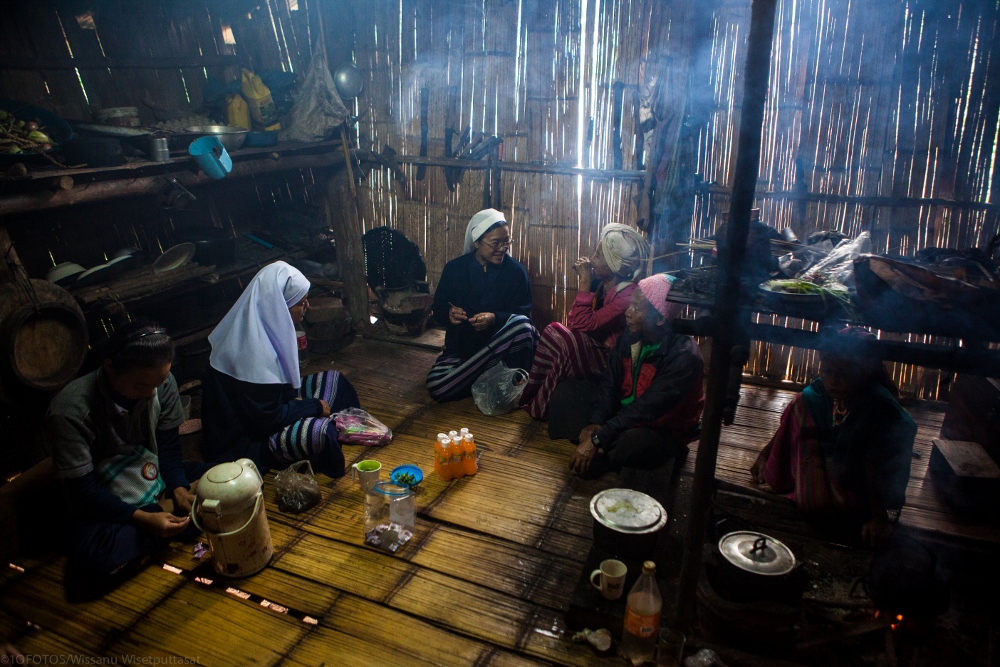 Sisters visiting a Karen family in their home. (Provided photo)