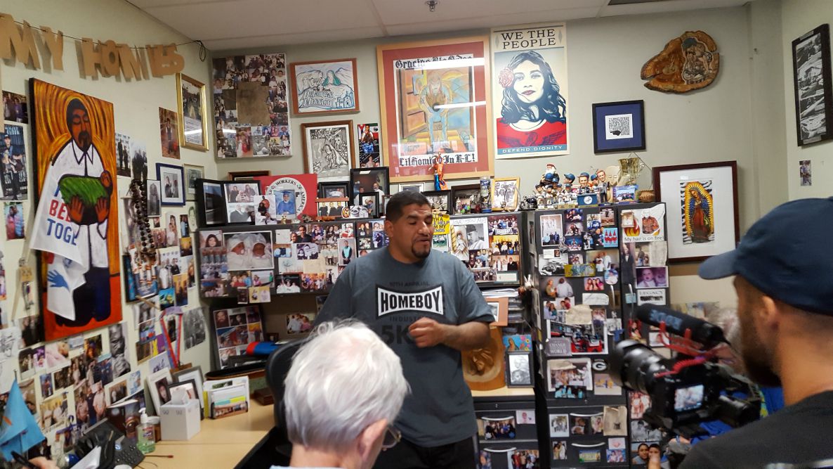 George shows us around Fr. Greg Boyle's office at Homeboy Industries in Los Angeles on Oct. 8. (GSR photo / Michele Morek)