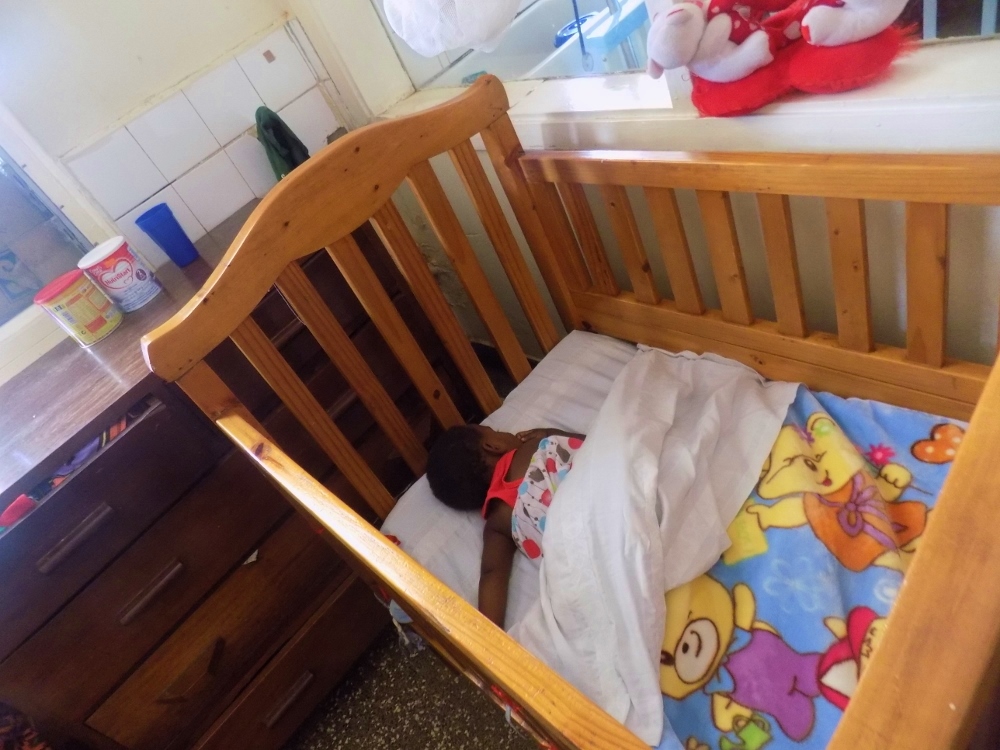 A child sleeps at the Nsambya Babies Home, where around 30 children live at a time. (Courtesy Nsambya Babies Home/Moise Mbula)