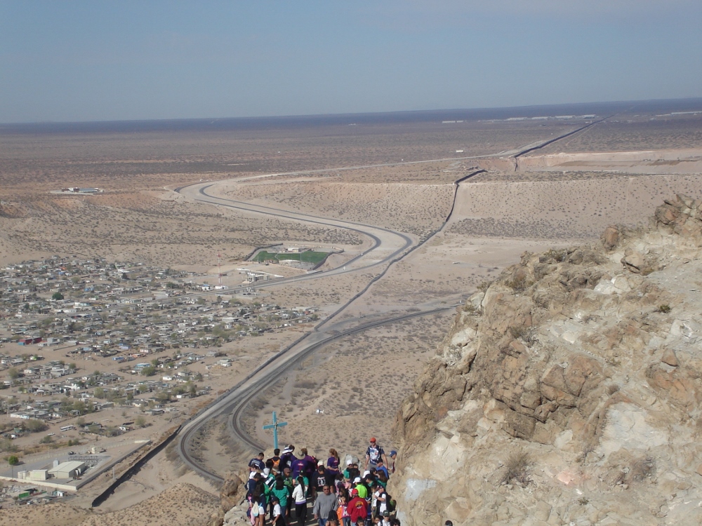 The border fence is seen dividing Sunland Park, N.M., and Anapra, Mexico during the Migrant Way of the Cross on Good Friday, 2013, from Mt. Cristo Rey. (Tracy Kemme)
