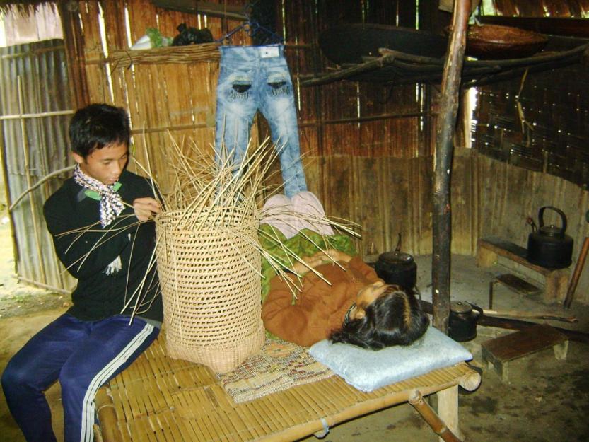 Ho Van Son, a 14-year old ethnic Pa Co, makes a bamboo basket for a living, looking after his bedridden mother suffering from a serious lung disease. Son left school eight years ago. (Peter Nguyen)