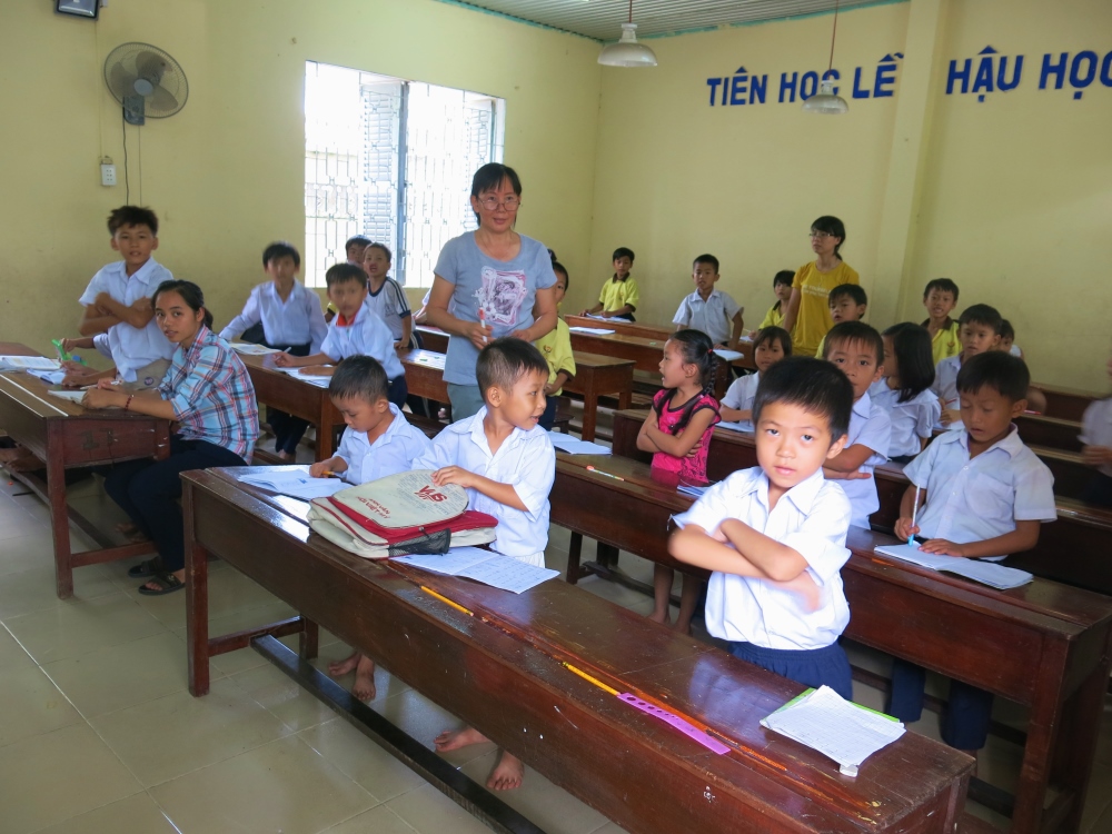 First graders, ranging in age, practice their writing in class at Sacred Heart Love School, which is run by Our Lady of the Mission Nuns outside of Ho Chi Minh City in Vietnam. The sisters’ school specifically caters to children of migrant workers, whose education is interrupted by moving frequently. Their work flies under the official eye of the government, which prohibits religious groups from running schools and health care centers. (Mary Nguyen)