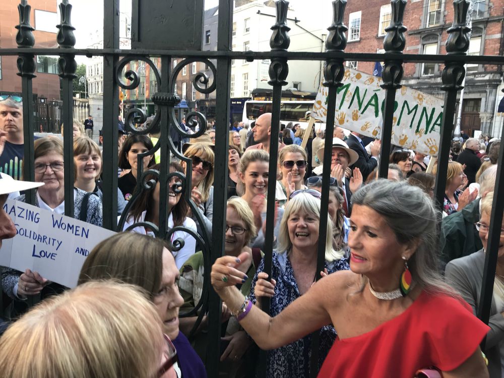 Gabrielle O'Gorman, in red, attends the Aug. 26 "Stand4Truth" demonstration in Dublin. O'Gorman, 73, spent six weeks at the Sean McDermott Street laundry before she was sent to the laundry run by the Good Shepherd Sisters in Limerick for two and a half years. (Courtesy of Gabrielle O'Gorman)