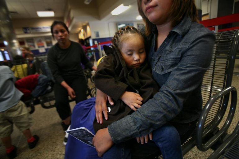 Janet Perez of Guatemala holds her daughter, Ariana,3, after being released from the South Texas Family Residential Center in Dilley, Texas, on July 14. She and other immigrants were at the Greyhound bus station in San Antonio waiting for buses that would take them to be reunited with family and friends. (GSR/Nuri Vallbona)