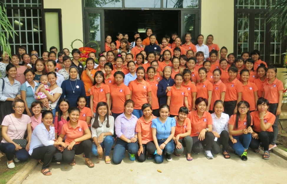 Housemaids, dressed in orange uniforms, and their children attend the 10th anniversary celebration at the Phuoc Loc Vocational Training Center in southern Vietnam about 50 miles from Ho Chi Minh City. (GSR photo / Joachim Pham)