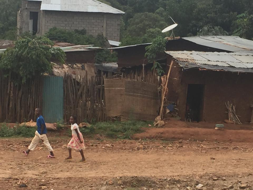 Some children walking by typical houses that are near the sisters' compound. (Angela Mahoney)