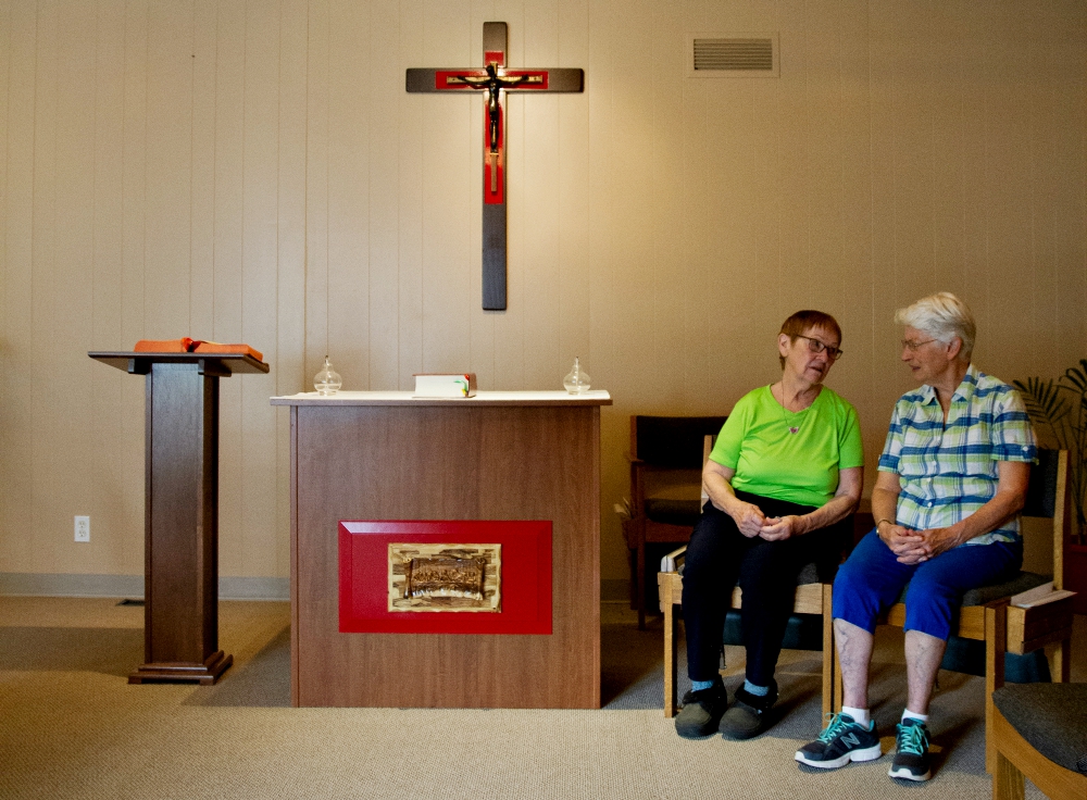 Delphine Busch, left, and Sr. Lucinda Peightal of the Sisters of the Holy Names of Jesus and Mary chat after a Monday morning service in the chapel at St. Peter Catholic Church in Portland, Oregon. (Benjamin Derrell Thompson)