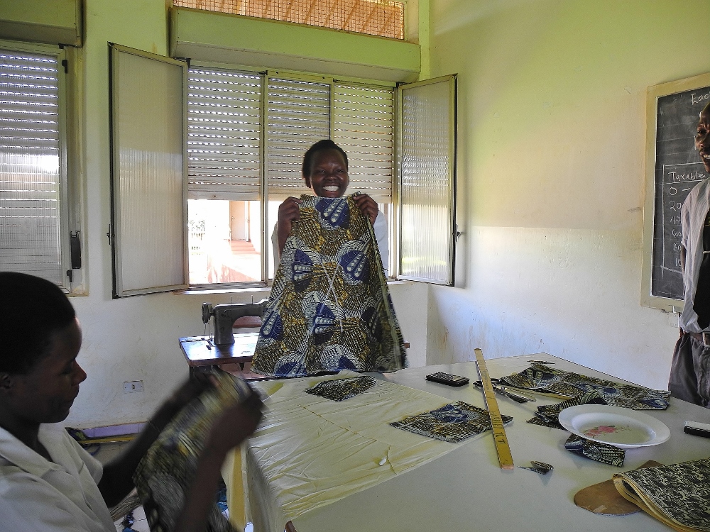A student in the tailoring program at St. Monica center shows off a skirt she is sewing. (Melanie Lidman)