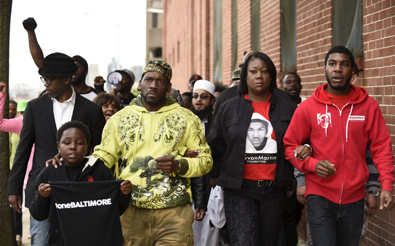 Travon Martin’s mother, Sybrina Fulton (second from right), and his brother, Jahvaris Fulton (right), join a march around the Baltimore Central Booking and Intake Center May 1. (Newscom/Reuters/Sait Serkan Gurbuz)