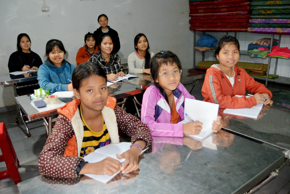 Mary Ben (wearing glasses) and her friends study math in advance of the coming school year. (Joachim Pham)